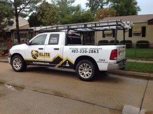 White pickup truck with Elite Roofing logo.