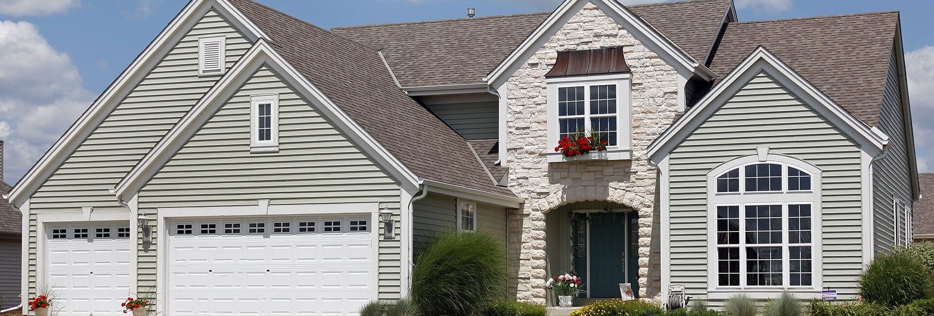 Two-story house with white siding and a garage.