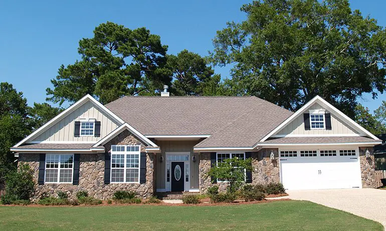 Stone house with a garage door.