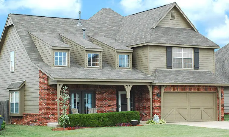 Brick house with a large garage door.