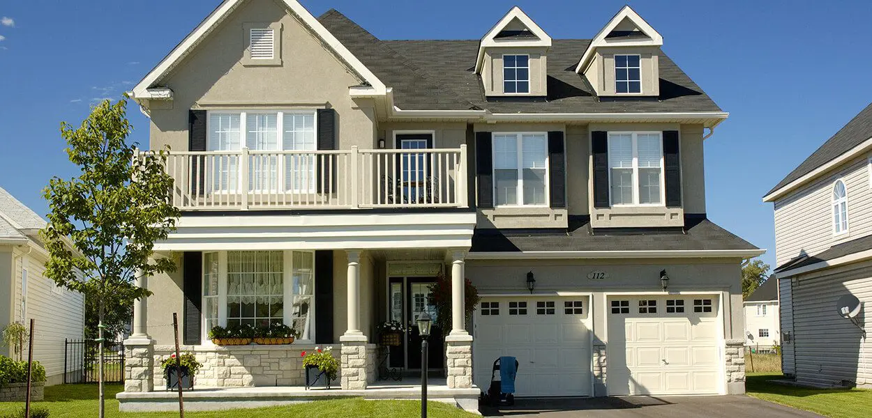 Two-story house with garage and balcony.