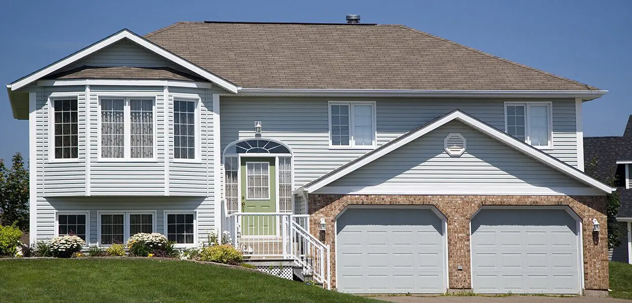 Gray house with a double garage door.