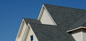 Close-up of gray shingle roof on house.